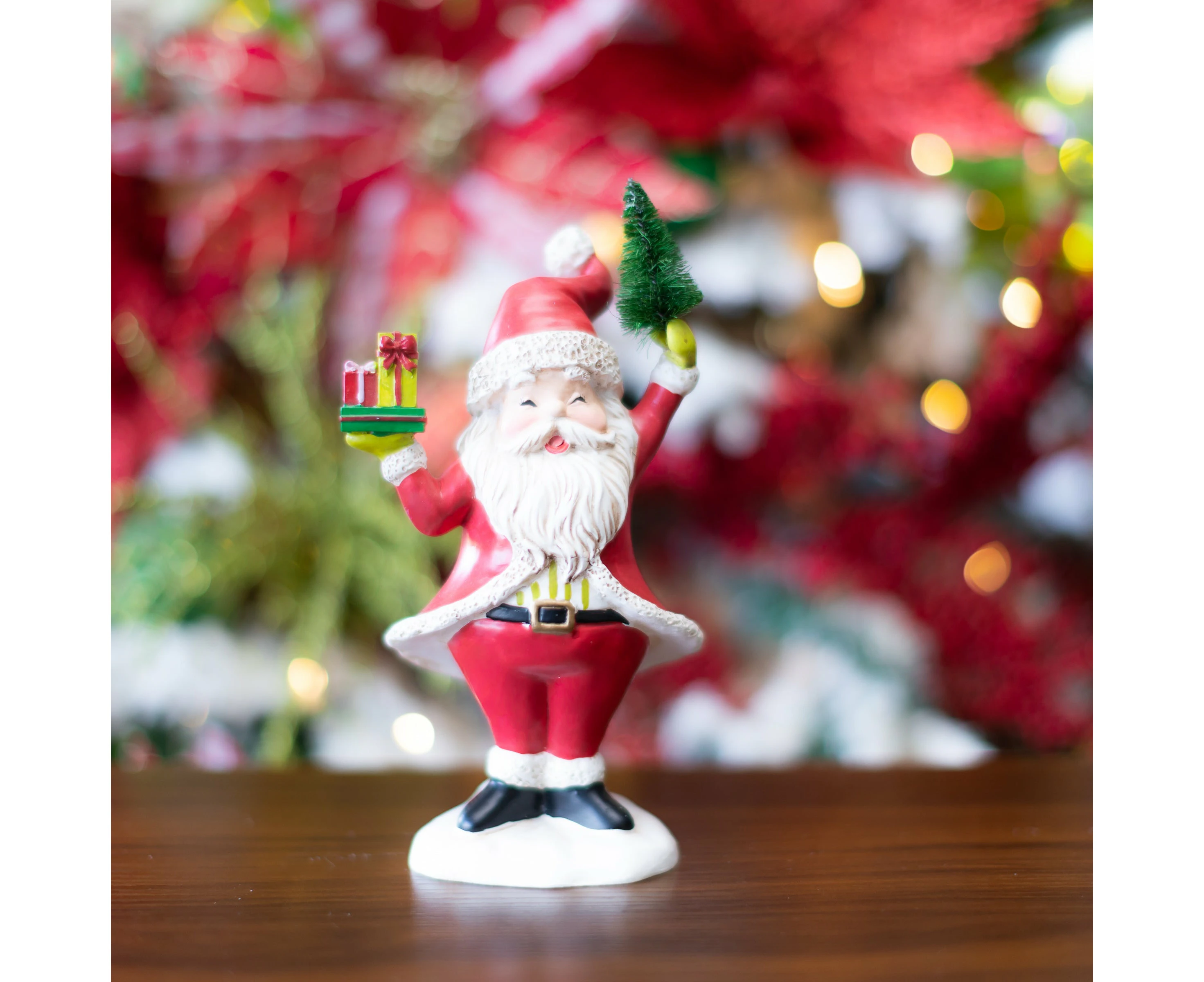 Santa Holding a Sisal Tree and Wrapped Gifts